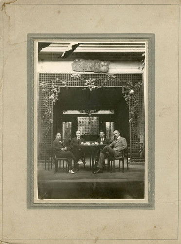 Men having tea in an arcade area, with Roy Maxwell Talbot included