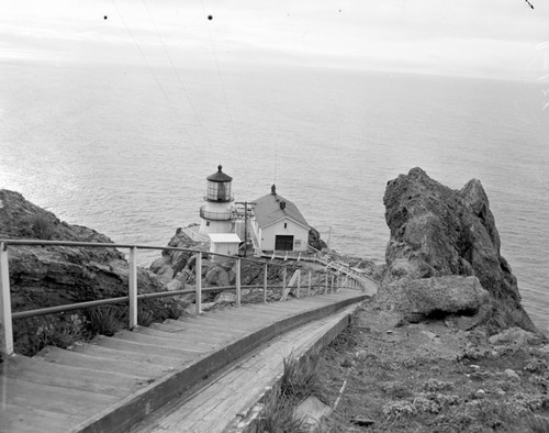 View down steps to lighthouse, and then back at light with shades drawn to protect frexnel lens from damage by the afternoon sun