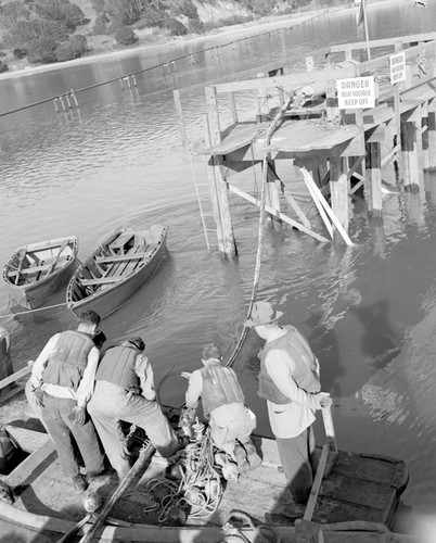 Laying telephone cable from Pt. Reyes across Tomales Bay, Marin Co., California. Cable entered the Bay at Chicken Ranch Beach. One view looks over caple laying south along the Inverness waterfront. 2, 3 Joe Sousa