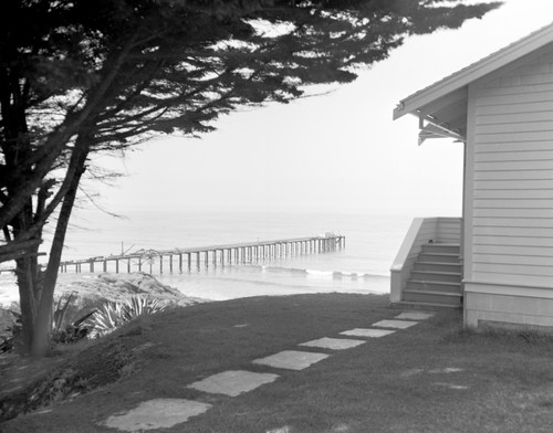 A beach and Scripps pier view at Scripps Institution of Oceanography near the front of the original library building. Circa 1950