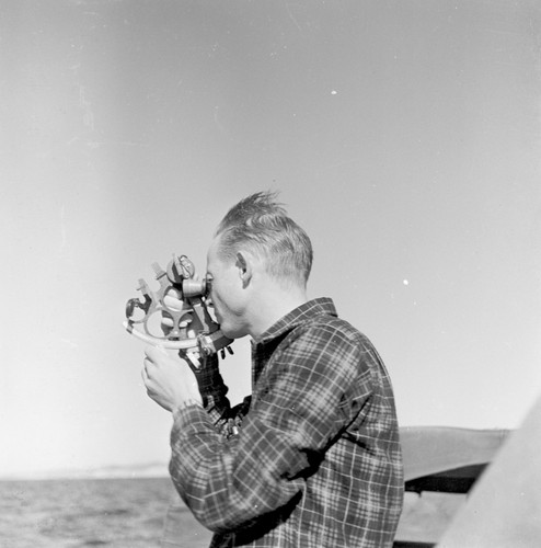 Douglas L. Inman taking bearings on dive sites. for an Offshore Sand Ripple study, 1948 for Fran Shepard. La Jolla Shores, California