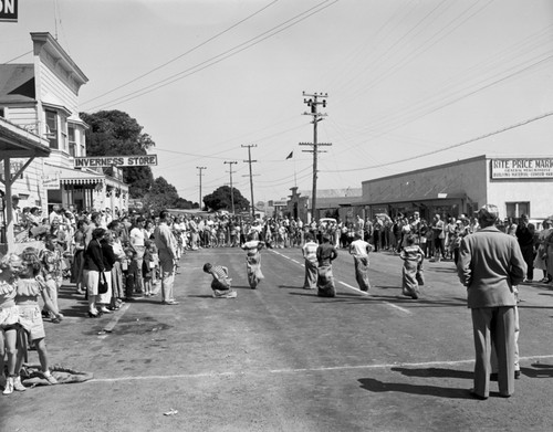 Fourth of July races, Inverness, Marin Co., California. Races are held today up First Valley, leaving busy main street free for traffic driving to Drakes Bay and Pt. Reyes, 1950's