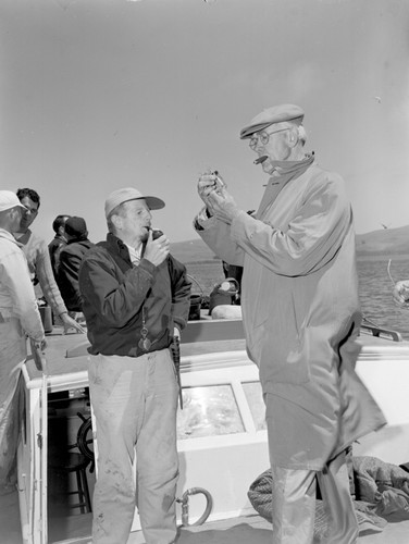 Marine biologists Joel Walker Hedgpeth (left) and Raymond C. Osborne (right) of Pacific Marine Station, Dillons Beach, California. They are checking some bryozoans samples on a field trip to Tomales Bay, a coastal estuary located on the central California coast north of San Francisco. Bryozoan are tiny colonial animals that generally build stony skeletons of calcium carbonate, superficially similar to coral. This photo was published in the Marin Independent Journal, a magazine for Marin County of California. Circa 1959