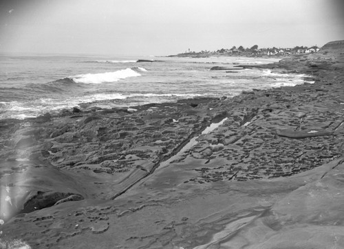 Water from the ocean eroded the rocks over time to create this drainage solution basin near La Jolla, California. This photo was published in journal called "Pacific Discovery" during this time frame. Circa 1950