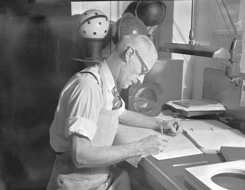 Construction scenes and lens grinding for panetarium in WWII optical shop at the California Academy of Sciences, Golden Gate Park, San Francisco, California. Dallas Hanna, in charge of the project, grinds lenses. Electrical relays came from gun turrets of B17 bombers declared surplus and dismantled in the basement of the Steinhart Aquarium. Two men were required to remove each patented bolt in the turret. Other lenses came from Fairchild areal camera sold through the State Board of Education as surplus for $25.00 each