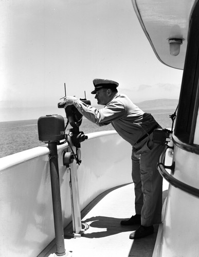 Fred Ziesenhenne takes bearing from bridge of Verlero IV. Allan Hancock Foundation, USC