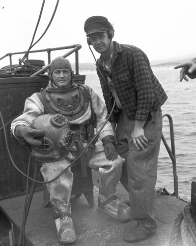 The "Salvager" employed by the Drakes Navigators Guild under Captain Adolph Oko Jr. (on the right), explores Drakes Bay near San Francisco for small vessels rumored to have been left by explorer Frances Drake in 1579. This photograph was published in the San Francisco Chronicle. September 23, 1951