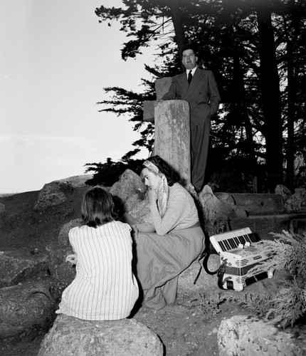 Celtic granite cross and driftwood commemorate explorer Sir Francis Drake's landing on the California coast in 1579 in Drakes Bay, Marin County, California. Charles Shrewsbury, rector of St. Colombo, is shown here conducting a service depicting the first reading of English Book of Common Prayer. Edith and Susy Williams the photographer's daughters model for the camera. Circa 1950