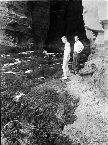 Marston Sargent a biologist at Scripps Institution of Oceanography and C.K. Tseng who would later be known as Zeng Chen-Kui a marine biologist in the Peoples Republic of China, depicted here collecting Gellidium (a type of seaweed) in the La Jolla Caves in La Jolla, California. Circa 1946-1948