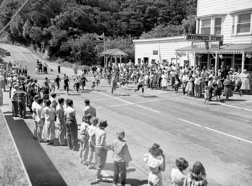 Fourth of July races, Inverness, Marin Co., California. Races are held today up First Valley, leaving busy main street free for traffic driving to Drakes Bay and Pt. Reyes, 1950's