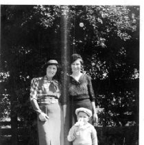 Two women with a child outdoors