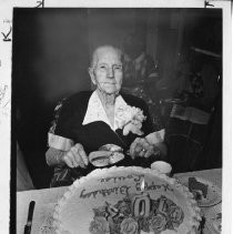 Louise Hjort, 103, prepares to slice into a cake. She lives at the Hillhaven Convalescent Hospital and worships at the First Baptist Church