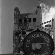 Signage on parking garage with Tower Bridge in background