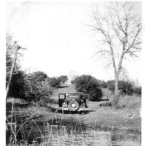 Automobile parked near a creek