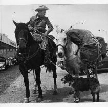 Bernhardt (Bob) Kleeman of Sacramento, who is traveling the Oregon Trail by horseback, in Red Bluff (on his horse Big Brill, with a pack mule and his dog Beauregard)