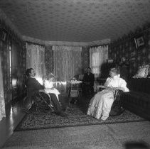 Interior view of a family seated in a living room