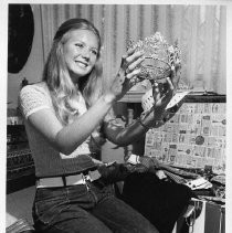 Laura Harrison, Miss Sacramento 1972, in her bedroom, holding her crown