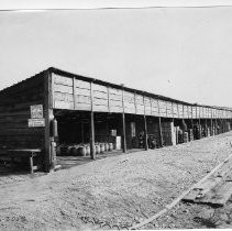 Exterior view of General Stores, number 4, Section 11 holding the paint and oil house. Note the sign warning "no smoking" near the building