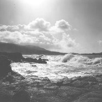 Waves gathering to crash on rocks