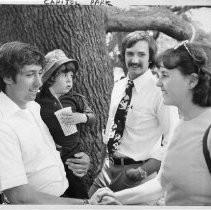 Tom Hayden (Thomas E. Hayden), antiwar and civil rights activist, speaking to voters in Capitol Park, Sacramento. He is holding his son with Jane Fonda, Troy Garity. He was a candidate for U.S. Senator from California (Democratic primary)