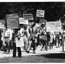Older demonstrators march at the California State Capitol to protest cuts in welfare and Social Security