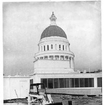 View of a tractor being used in the re-roofing project atop the California State Capitol's East Wing stood idle because of a rain storm