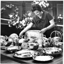 View of Beth Bruener with silver serving pieces and camellias