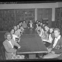 High school students sitting at a table in a library