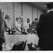 Here, Mayor and Mrs. Marriott (center) bow their heads in prayer at a breakfast