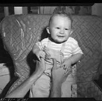 A baby sitting in a chair