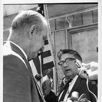 Jack Hickman, husband of Dr. Irene Hickman, an osteopath and the Sacramento County assessor, being interviewed by journalists