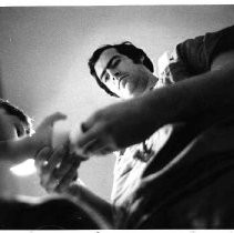 Dr. John Dresser tends the lacerated hand of a boy at the Sacramento Medical Center
