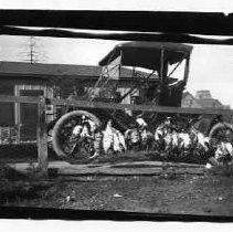 Photographs from Wild Legacy Book. Waterfowl hanging from a fence in front of an old car