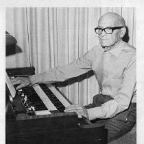 L. A. McArthur, retired band director in Willows, playing the organ in his home