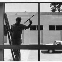 A window washer works on the windows of the temporary chambers for the state senate during the restoration project for the California State Capitol building