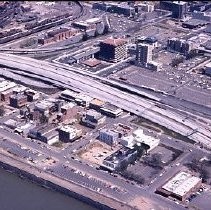 Views of redevelopment sites showing the demolition of buildings and reconstruction in the district. These views date from 1959 to 1970. These views date from 1959 to 1970. This view shows the I-5 freeway under construction looking north