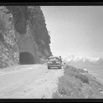 A road going through a cut in rock