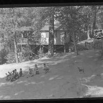 Children playing next to a cabin