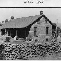 View of the Wildermuth House and the stone wall that surrounds it at Cam Seco ovrlooking the Pardee Reservoir in Calaveras County