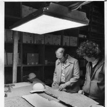 Workers look over samples of a portion of the plaster walls removed from the California State Capitol building during the restoration project