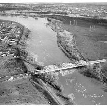 View of the American River at flood stage as it rises under the H Street Bridge in 1955