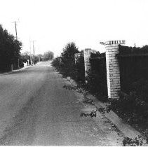 Street with fence and brick pillars