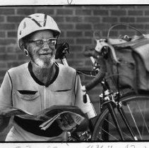 Alex MacDougall, cross-country bicyclist, with his bike, ready to leave for a trip