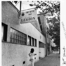 A woman stands outside the American Legion building at 1119 21st Street