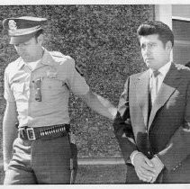 Juan Corona, accused mass murdered accompanied by Under Sheriff, Frank Cartoscelli, of Sutter County as they leave the Sutter County General Hospital