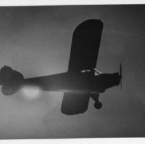 Bob Hitch, flying solo for the first time, in his family's airplane (shown in silhouette in photo)