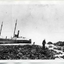 Photographs of landscape of Bolinas Bay. Photo of a ship run aground with two people nearby