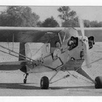 Mrs. Eve Hitch, beaming broadly, taxes her plane in after her solo flight