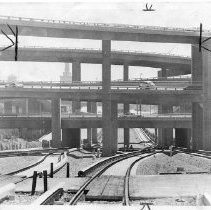 BART: Bay Area Rapid Transit, From ground level the tracks dive under multi-level freeways as the train approaches central Oakland