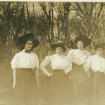 Four women with hats